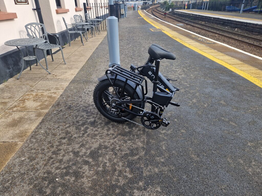engwe engine pro 2.0 e-bike folded up on a railway platform