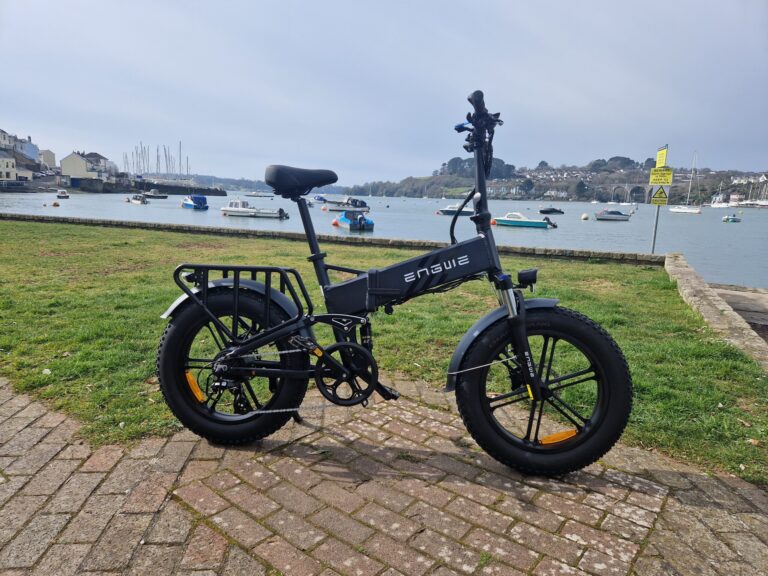 Engwe Engine |Pro 2.0 folding e-bike pictured on a green next to an estuary
